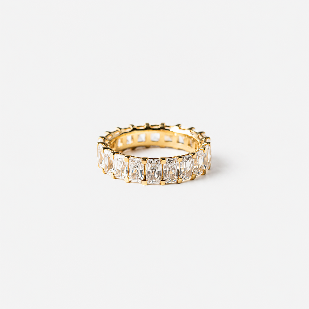 Gold ring with diamond stones on a white background