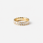 Gold ring with diamond stones on a white background