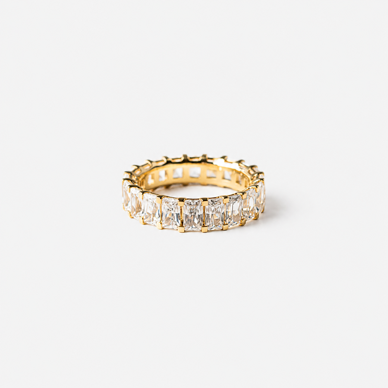 Gold ring with diamond stones on a white background