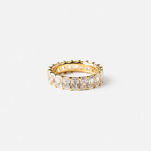 Gold ring with diamond stones on a white background