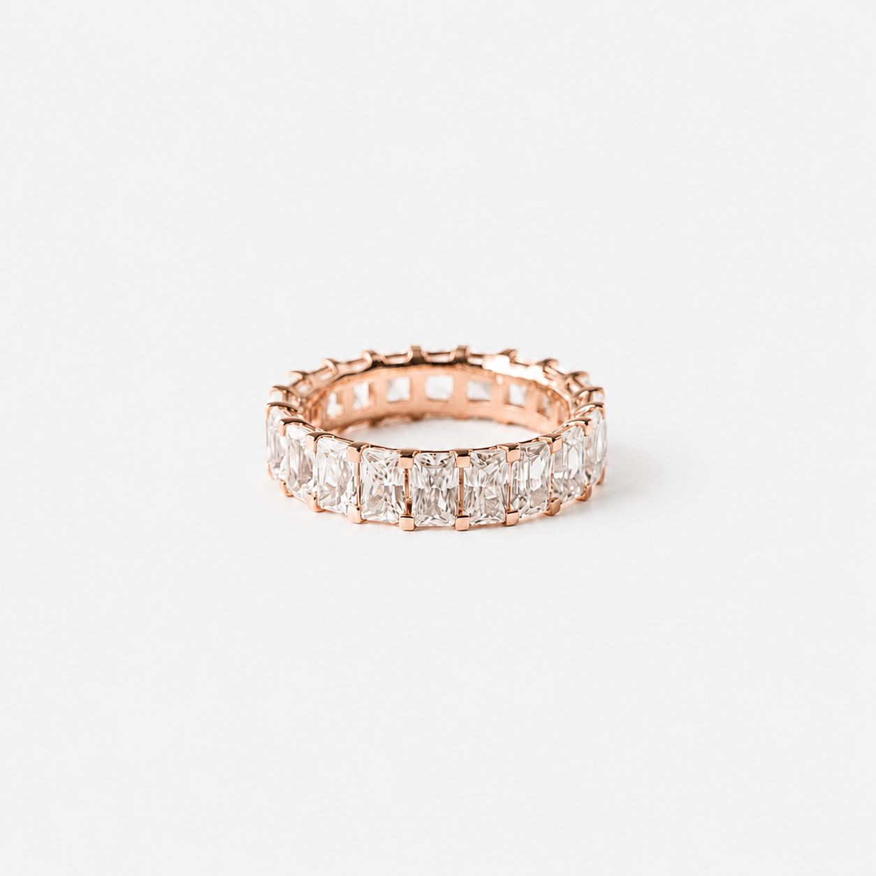 Rose gold ring with diamonds on a white background