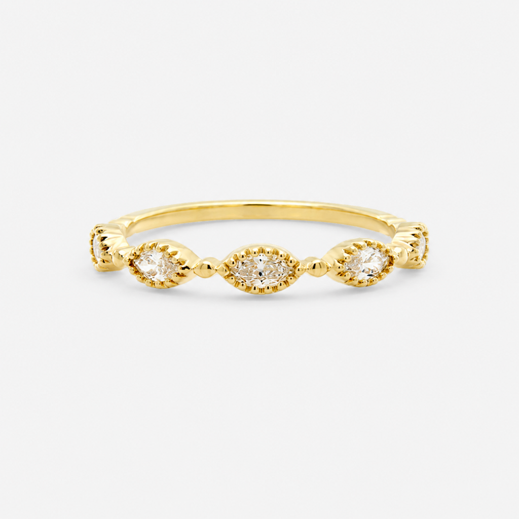 Gold ring with three small diamonds on a light gray background