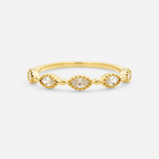 Gold ring with three small diamonds on a light gray background