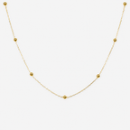 Gold necklace with small beads on a white background
