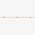 Gold bracelet with small beads on a white background