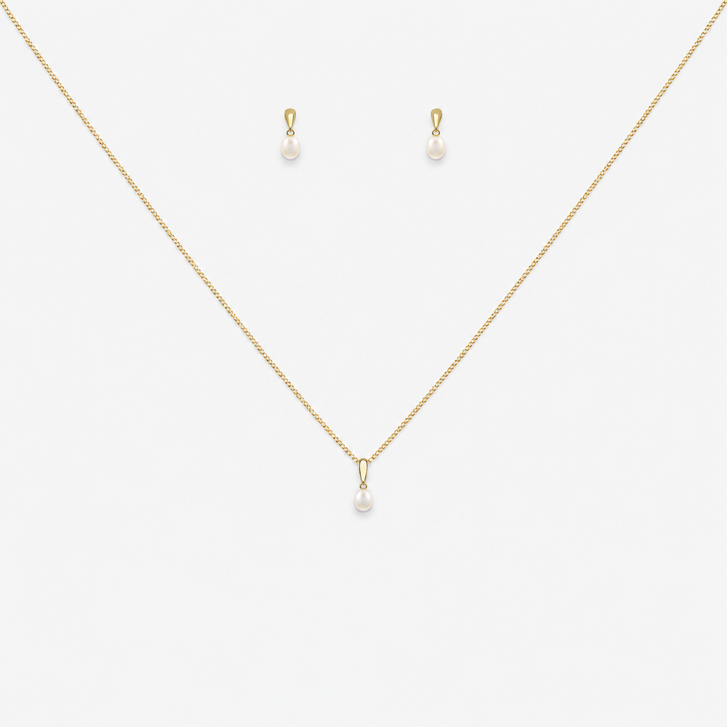 Gold necklace and earrings with pearl drops on a white background