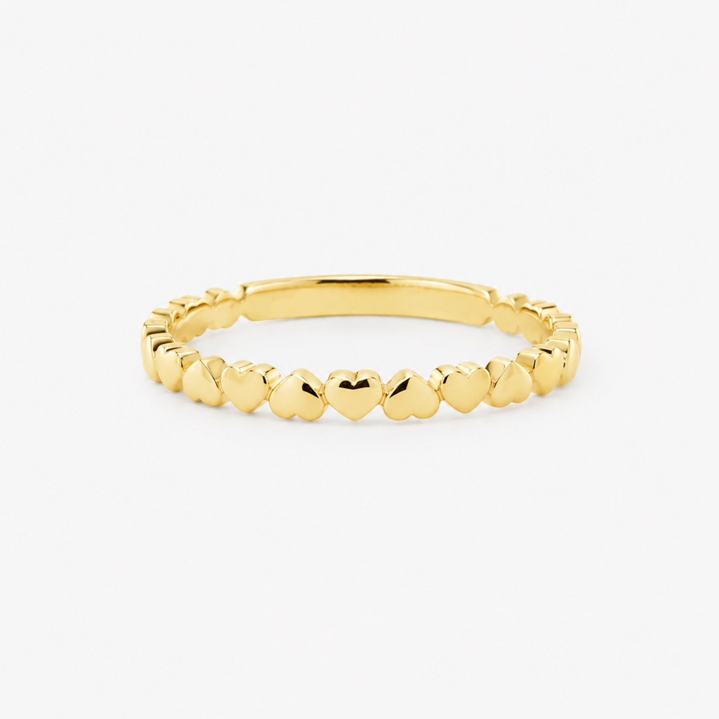 Gold ring with hearts on a white background