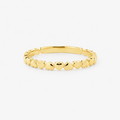Gold ring with hearts on a white background