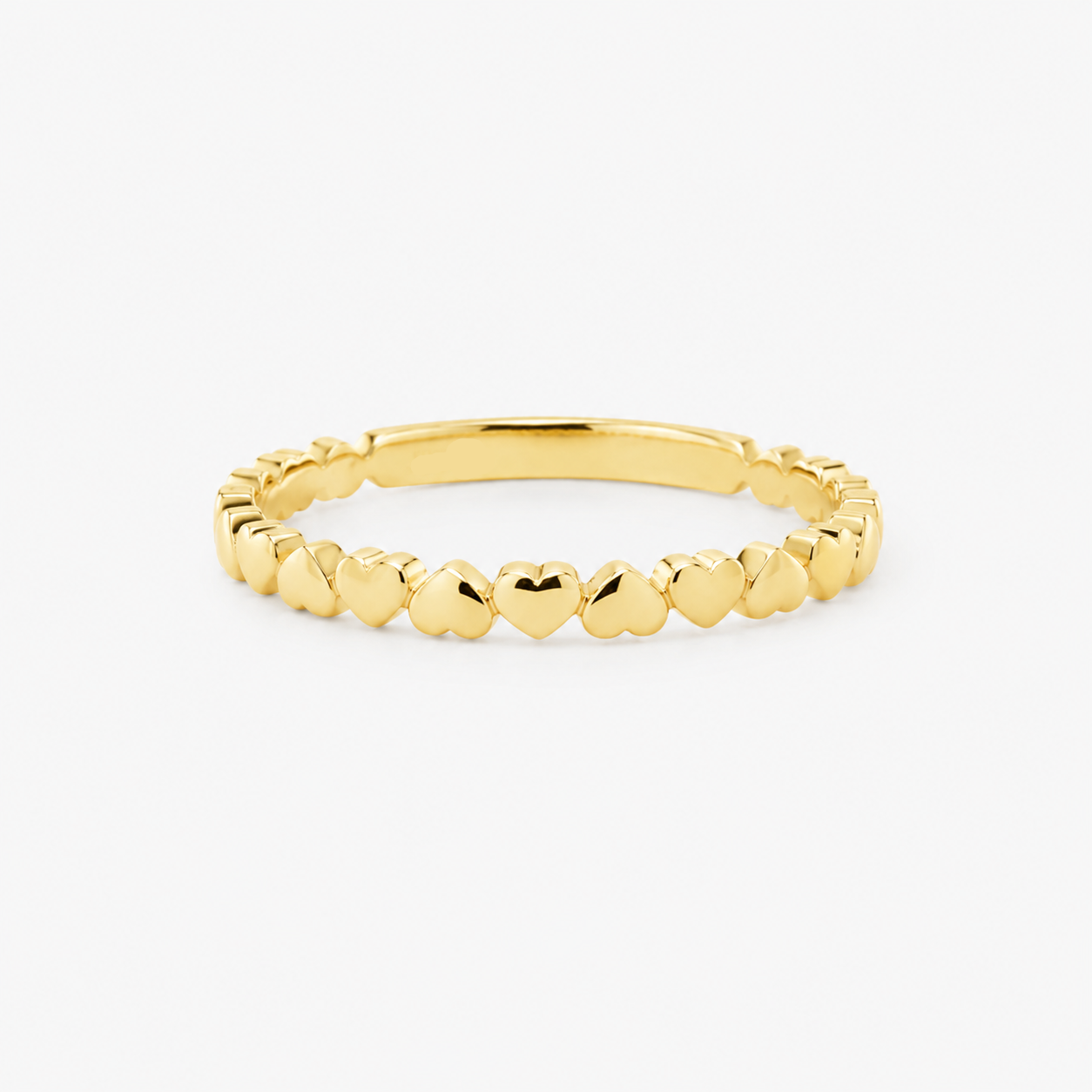 Gold ring with hearts on a white background