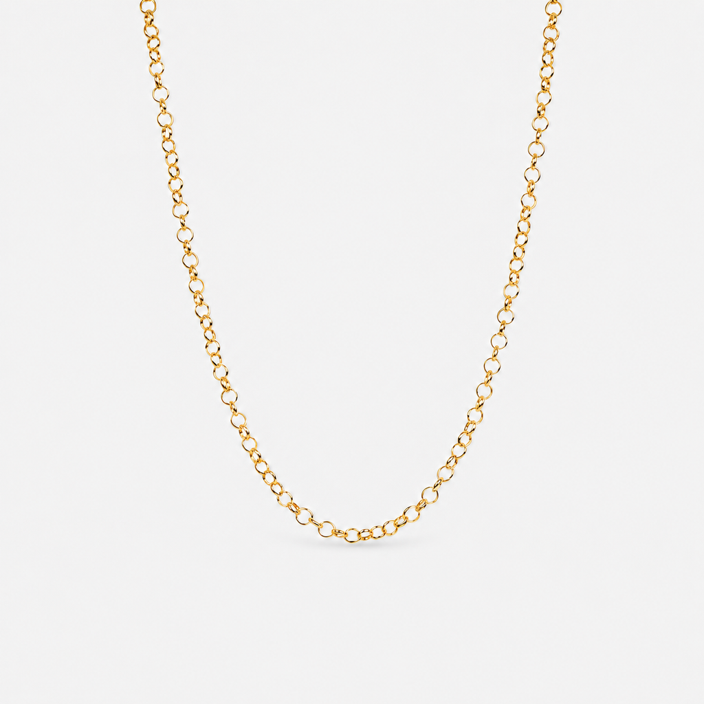 Gold chain necklace on a light gray background