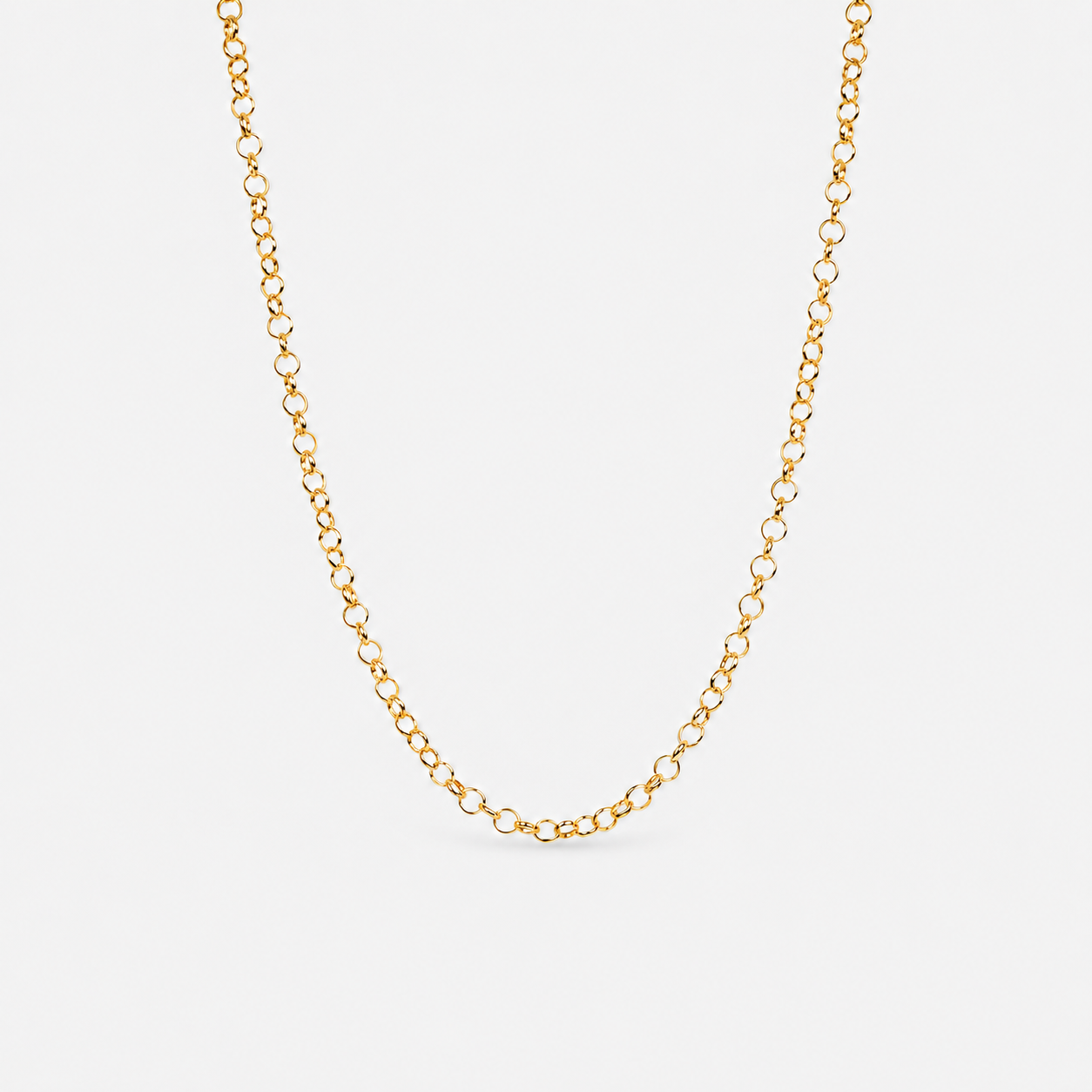 Gold chain necklace on a light gray background
