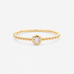Gold ring with a diamond on a white background
