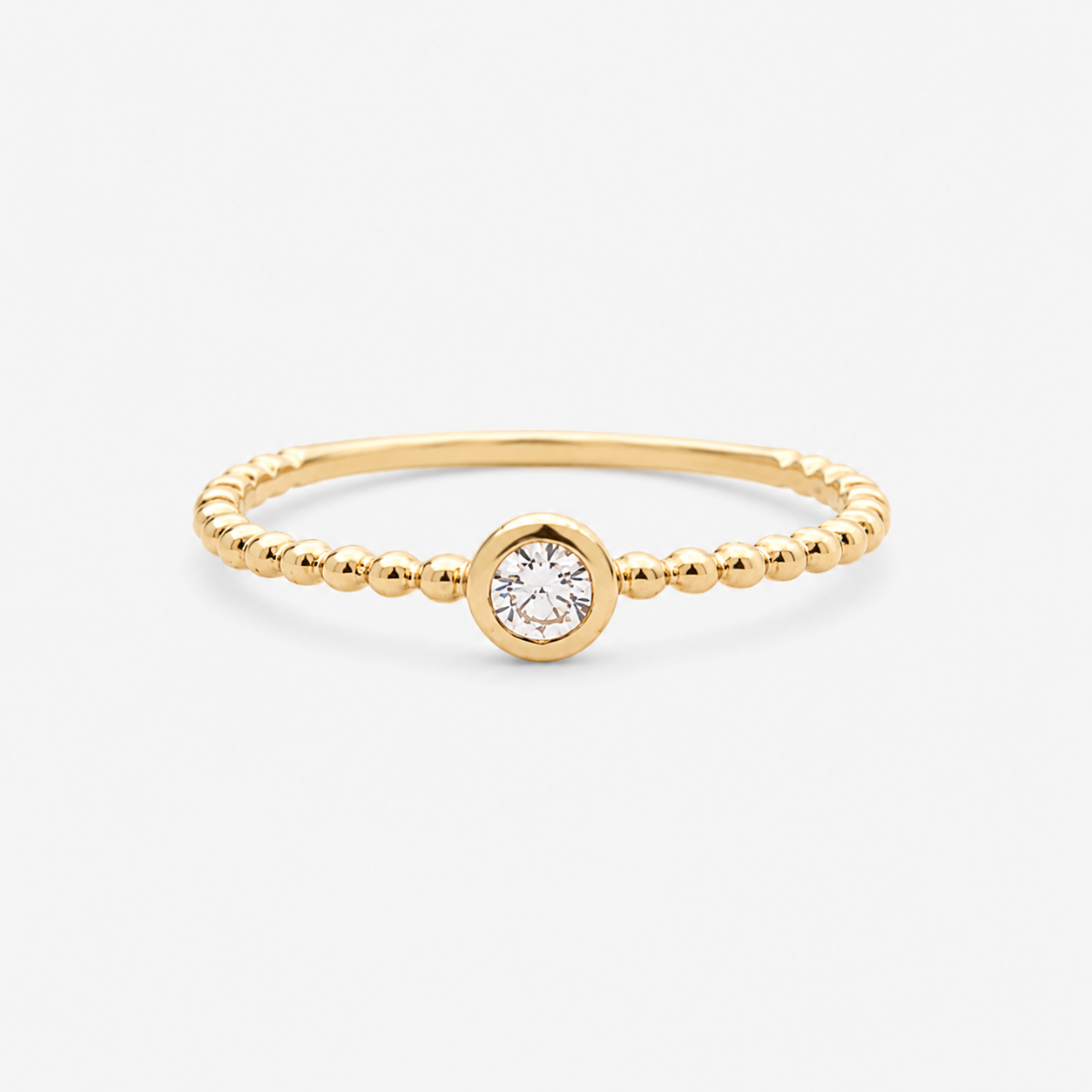 Gold ring with a diamond on a white background