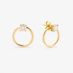 Gold hoop earrings with clear gemstones on a white background
