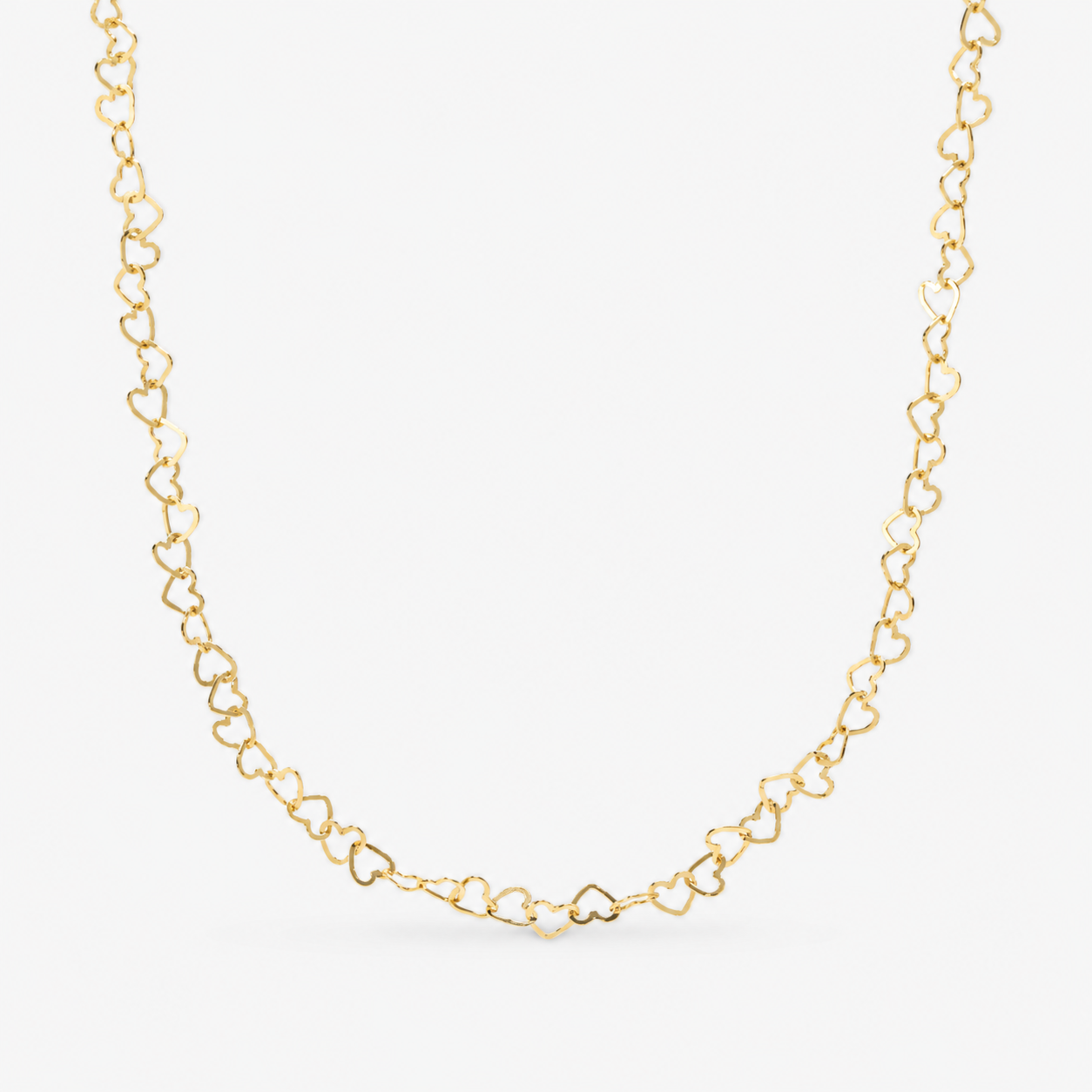 Gold heart-shaped chain necklace on a white background