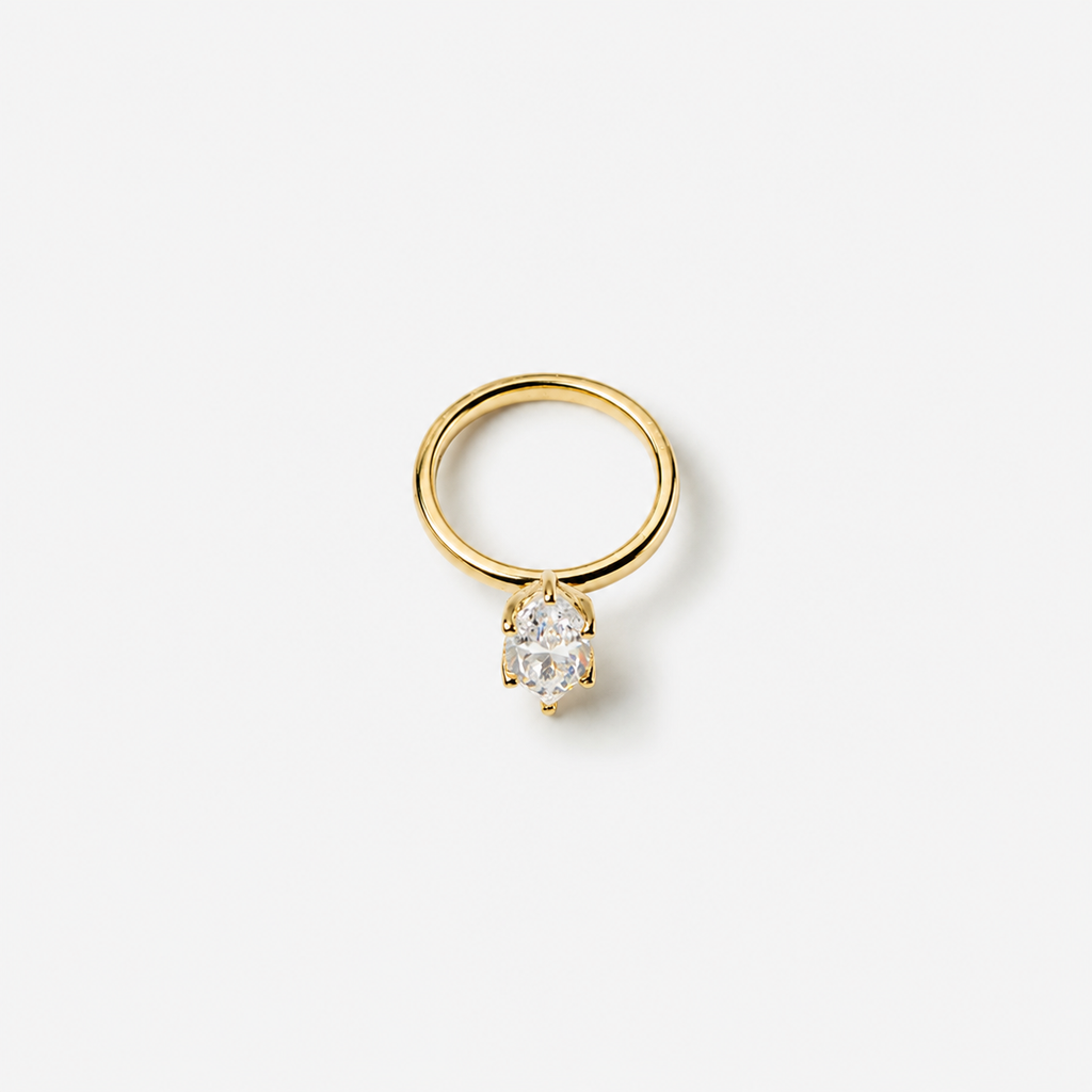 Gold ring with a diamond on a white background