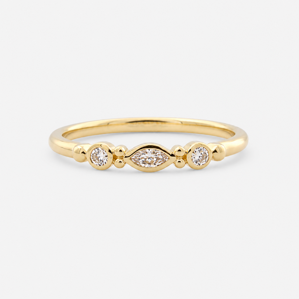 Gold ring with three diamonds on a white background