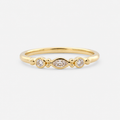 Gold ring with three diamonds on a white background