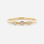 Gold ring with three diamonds on a white background