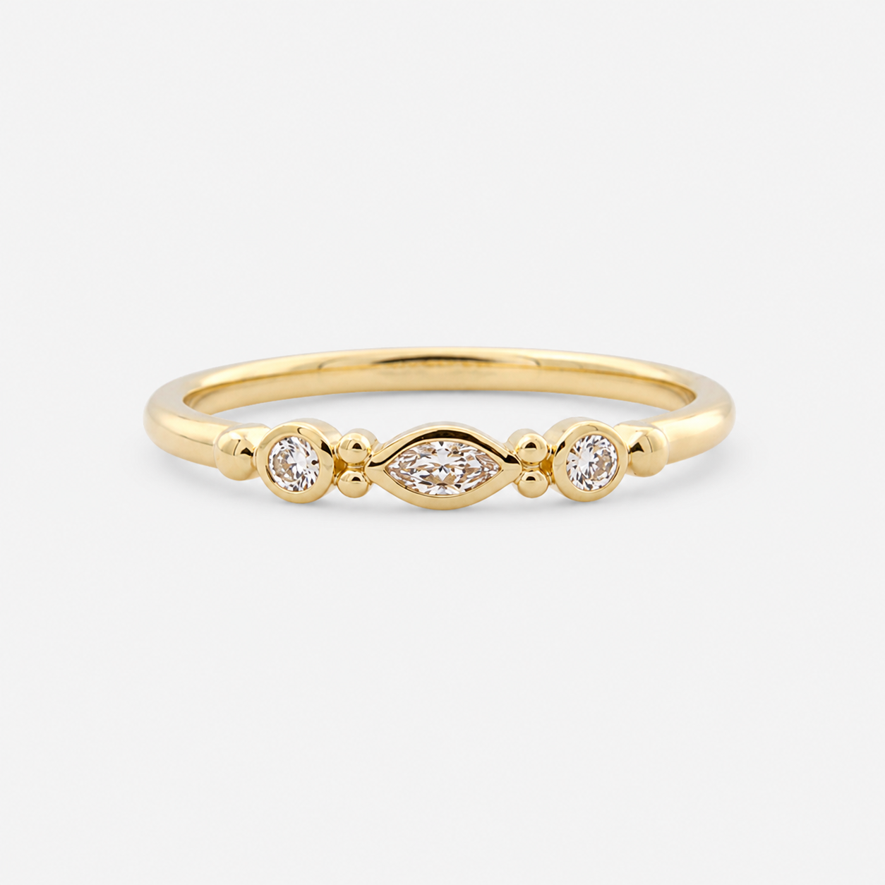 Gold ring with three diamonds on a white background