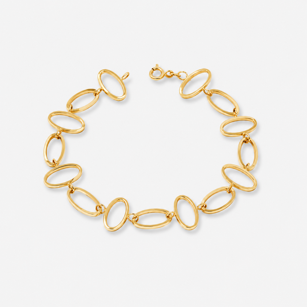 Gold chain bracelet on a light gray background