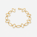 Gold chain bracelet on a light gray background