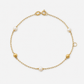 Gold bracelet with pearls on a white background