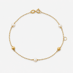 Gold bracelet with pearls on a white background
