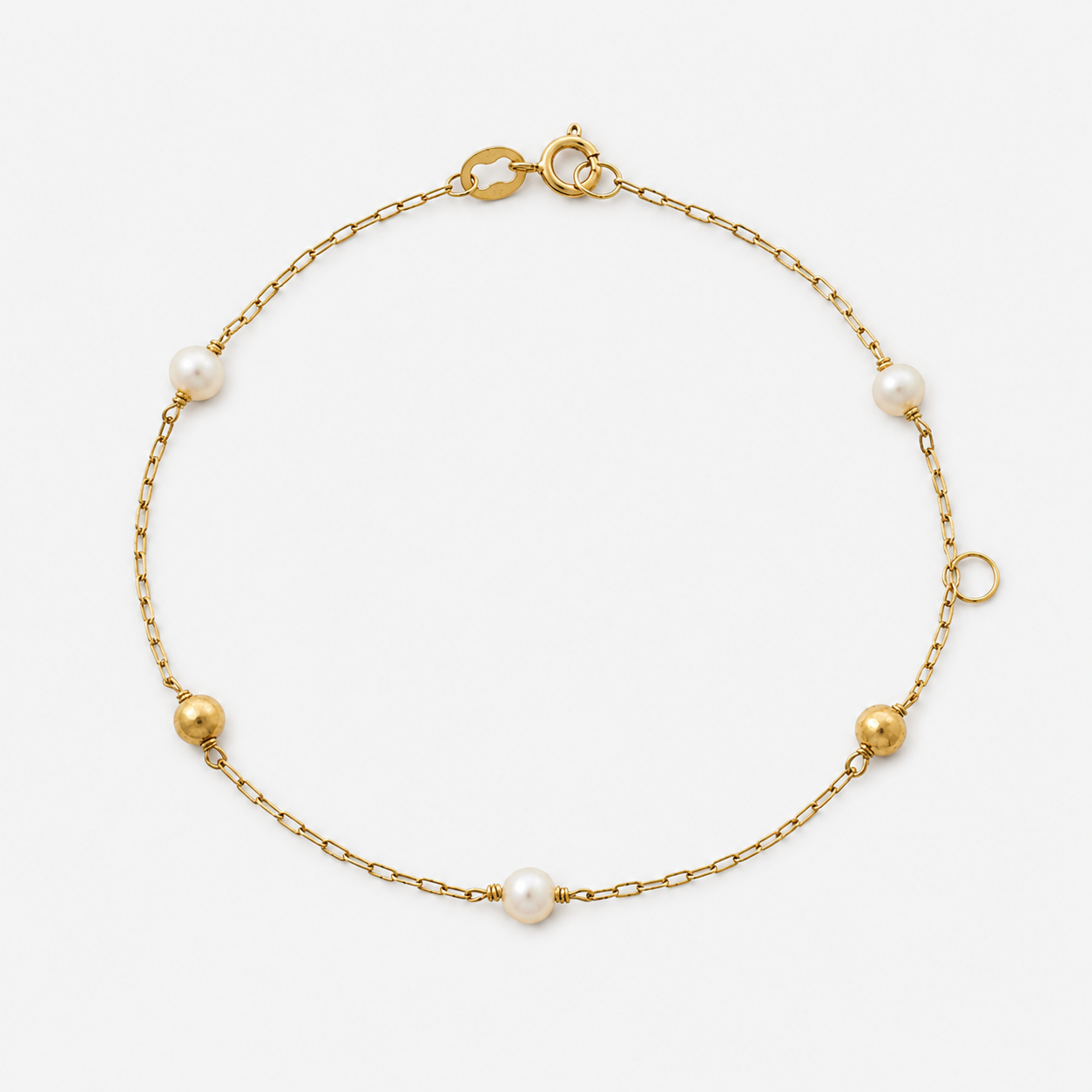 Gold bracelet with pearls on a white background