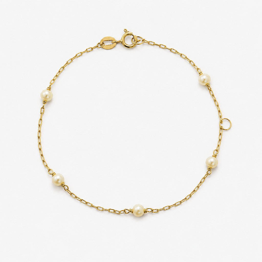 Gold bracelet with pearls on a white background