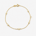 Gold bracelet with pearls on a white background