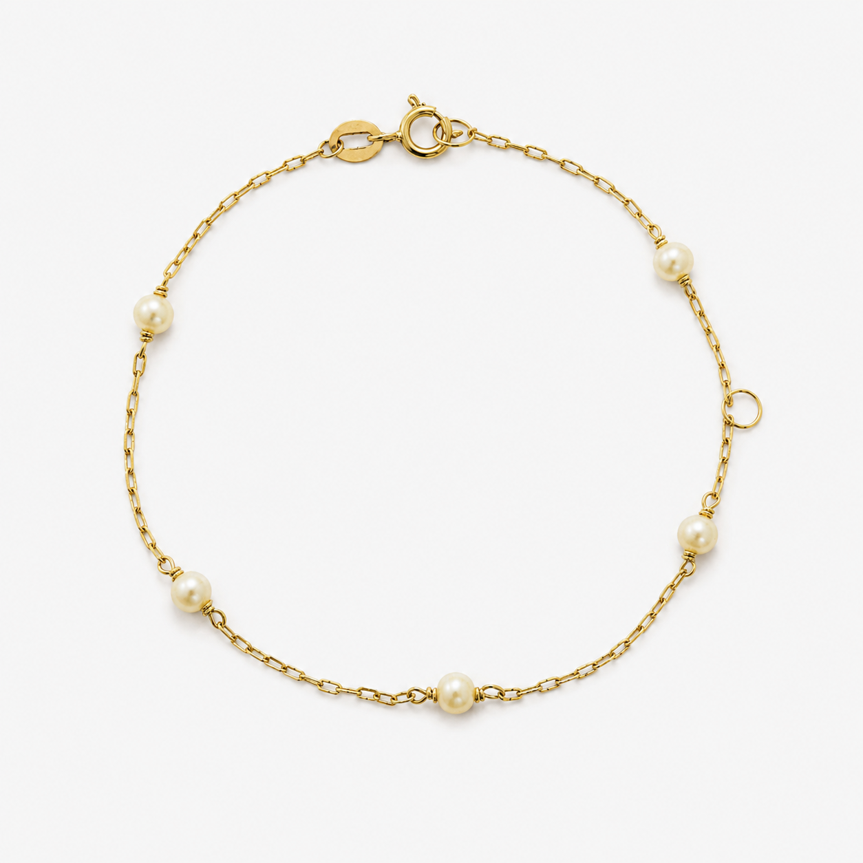 Gold bracelet with pearls on a white background
