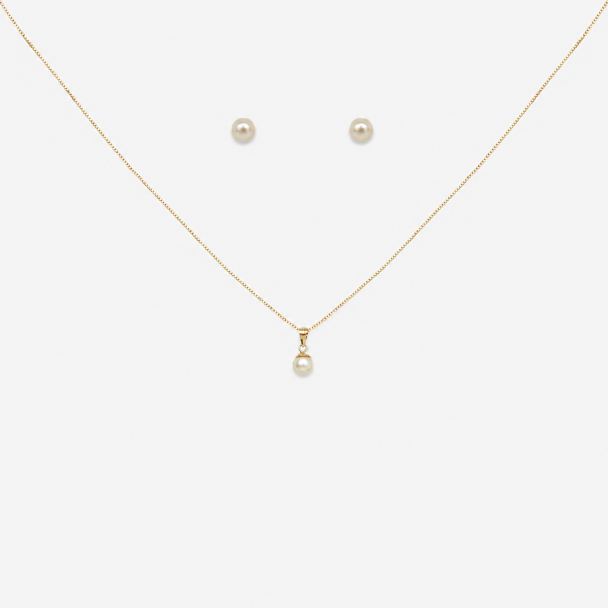 Pearl necklace and earrings on a white background