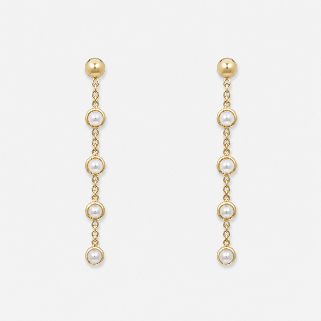 Gold chain earrings with pearl drops on a white background