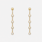 Gold chain earrings with pearl drops on a white background
