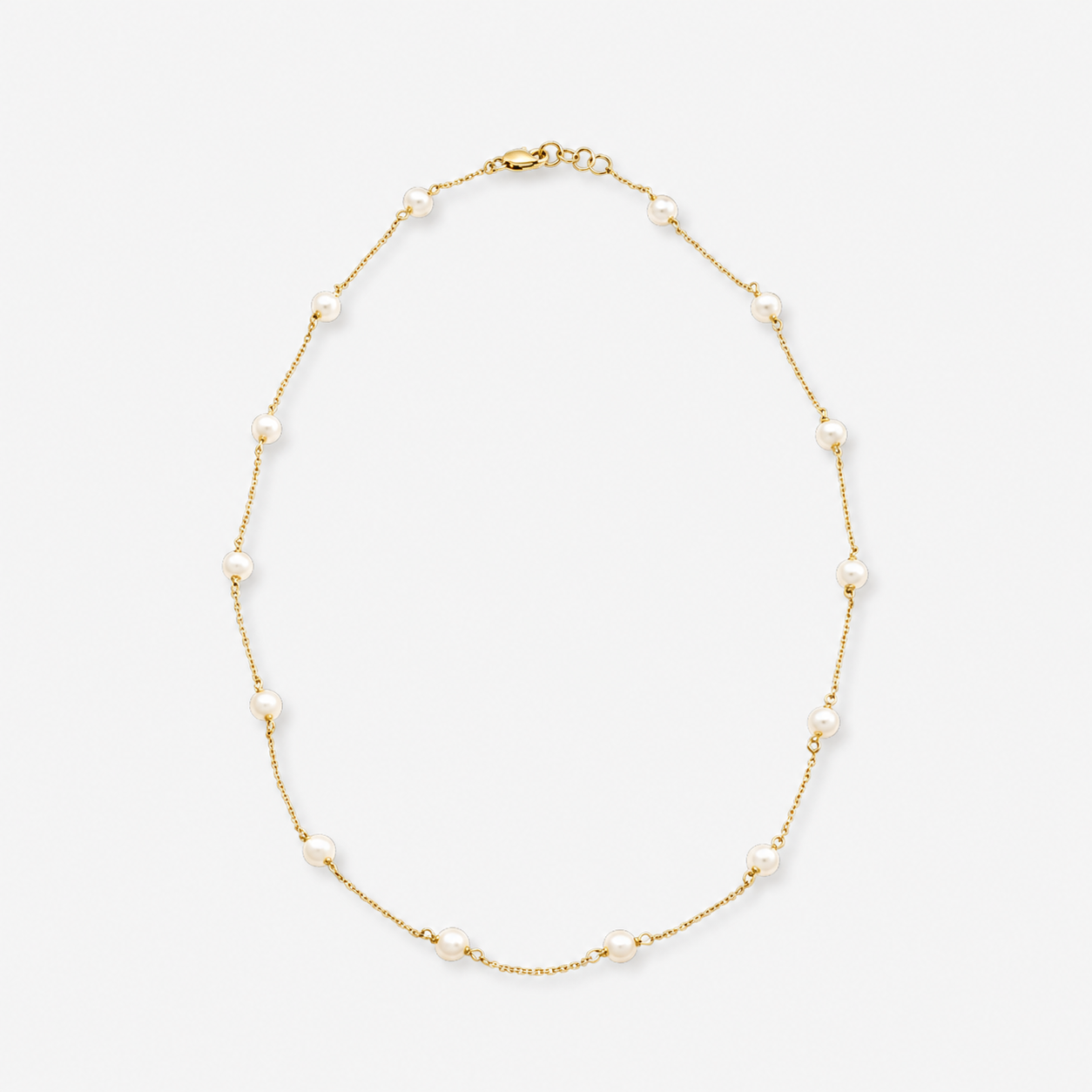 Gold necklace with pearls on a white background