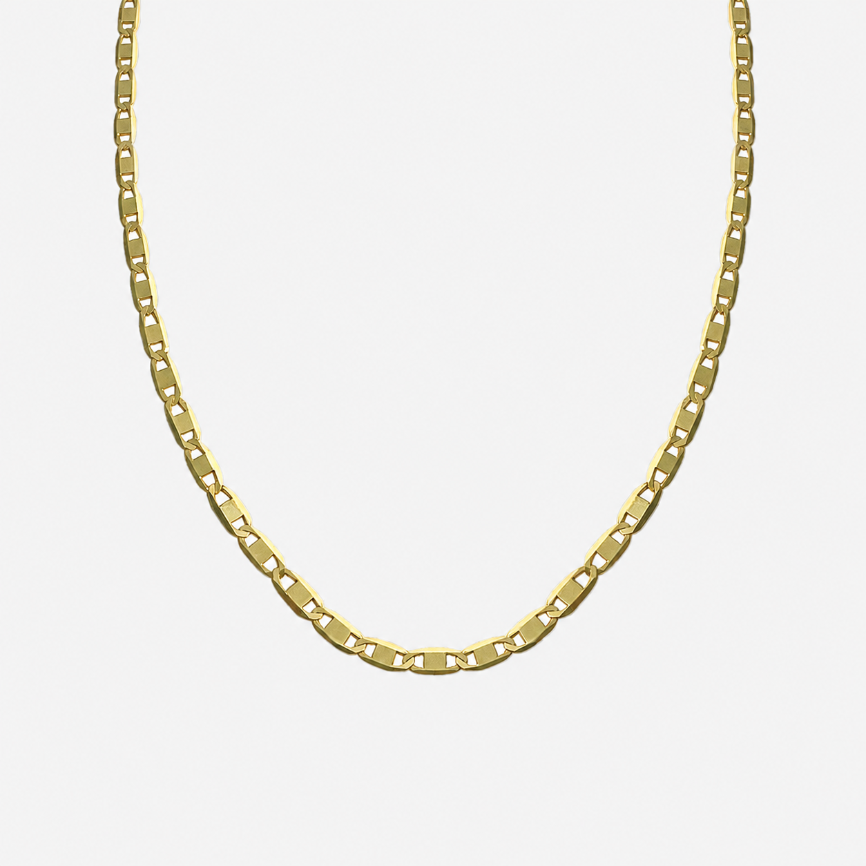 Gold chain necklace on a light gray background