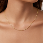 Gold necklace on a person's neck with a neutral background