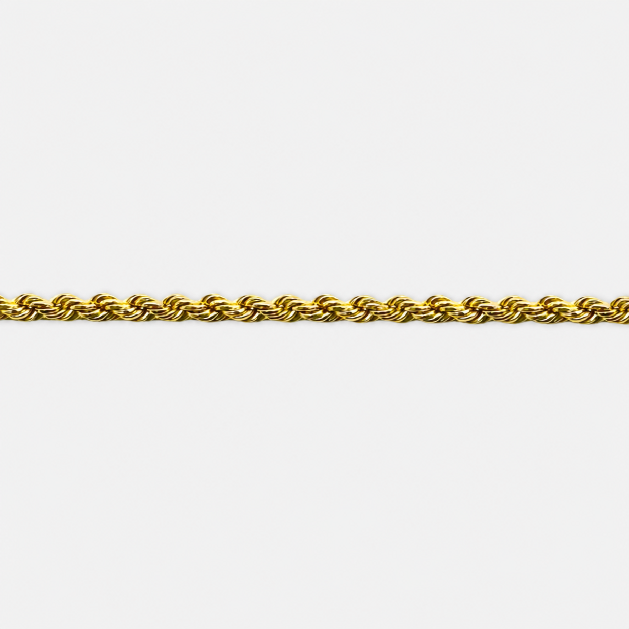 Gold rope chain on a white background