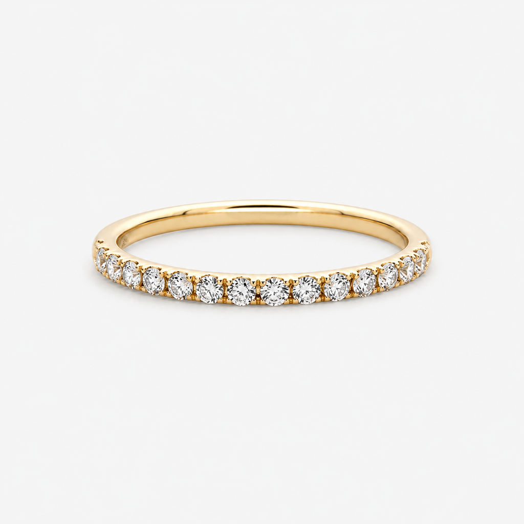 Gold ring with small diamonds on a light gray background