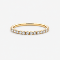Gold ring with small diamonds on a light gray background
