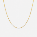 Gold chain necklace on a light gray background