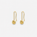 Gold earrings on a light gray background