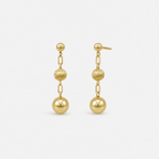 Pair of gold earrings with spherical beads on a white background