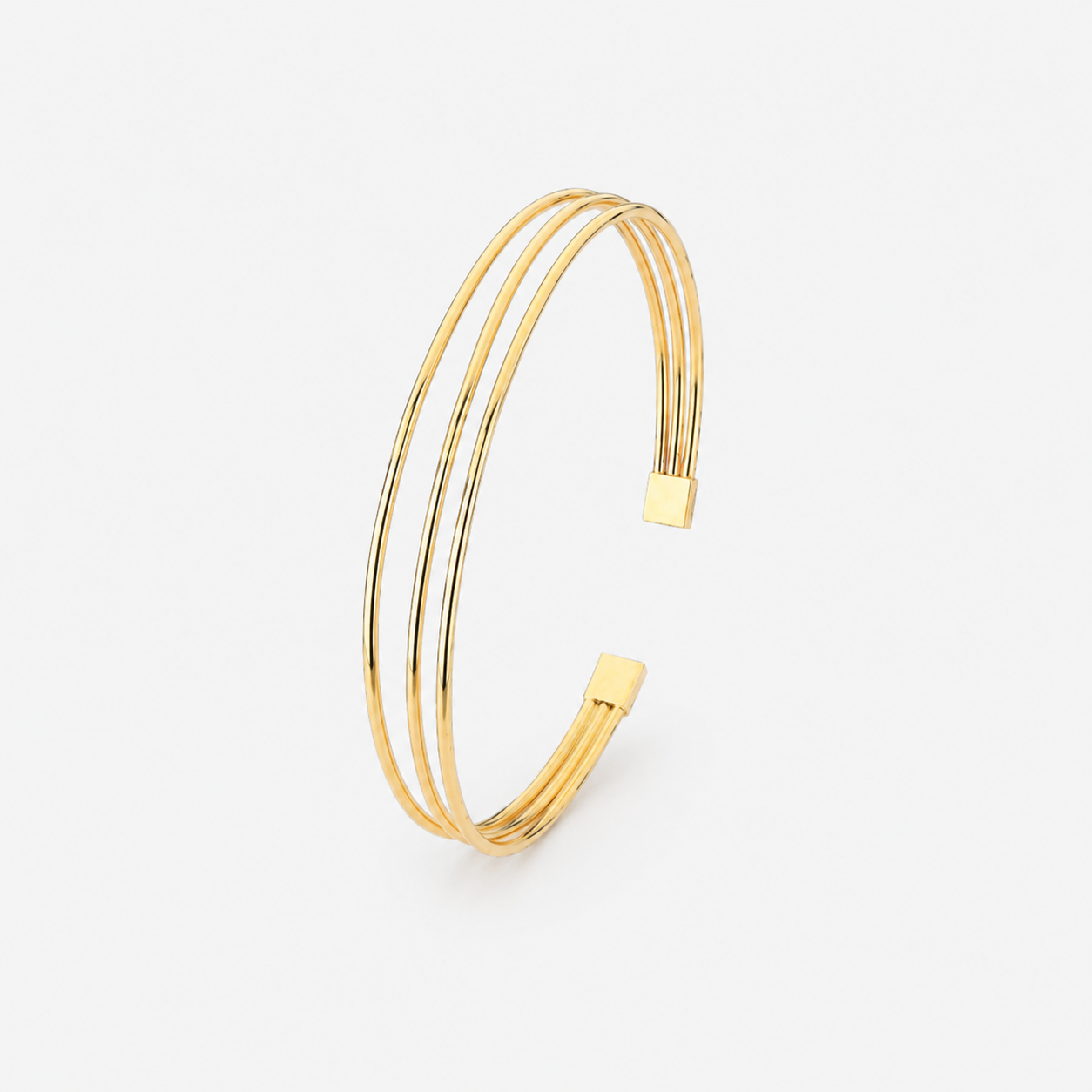 Gold bangle on a light gray background
