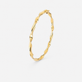 Gold hoop earring on a light gray background