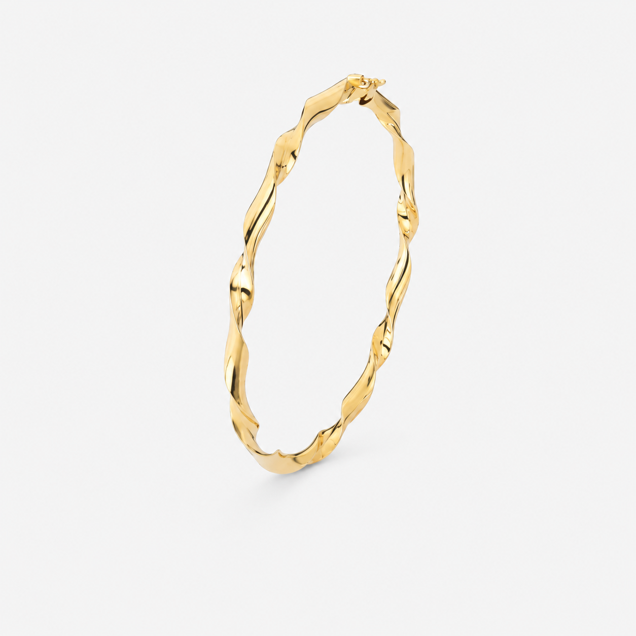 Gold hoop earring on a light gray background