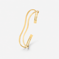 Gold bracelet on a light gray background