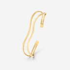 Gold bracelet on a light gray background