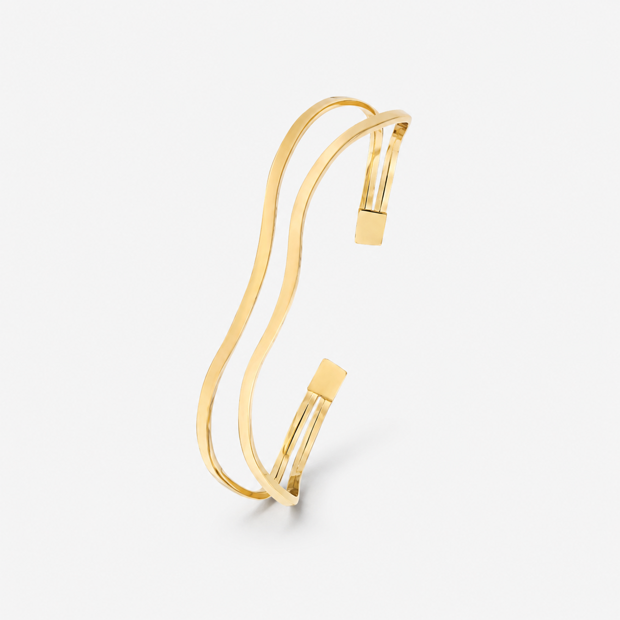 Gold bracelet on a light gray background